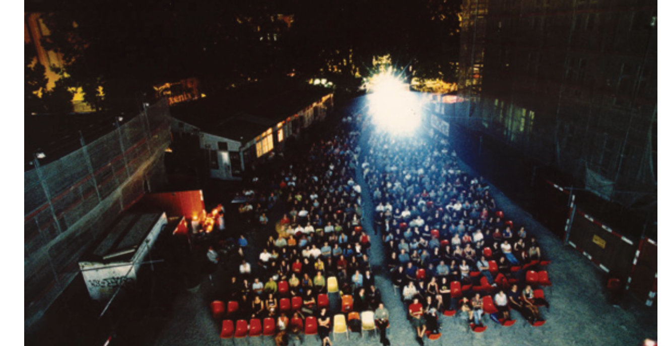 Open-air cinema audience at night