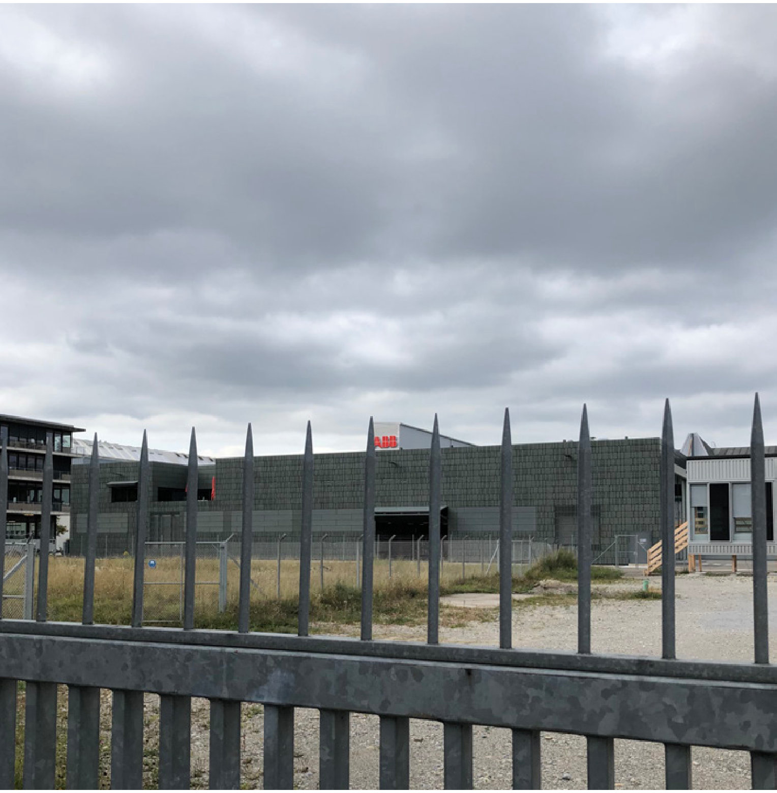Fenced vacant lot in Seebach under a grey sky